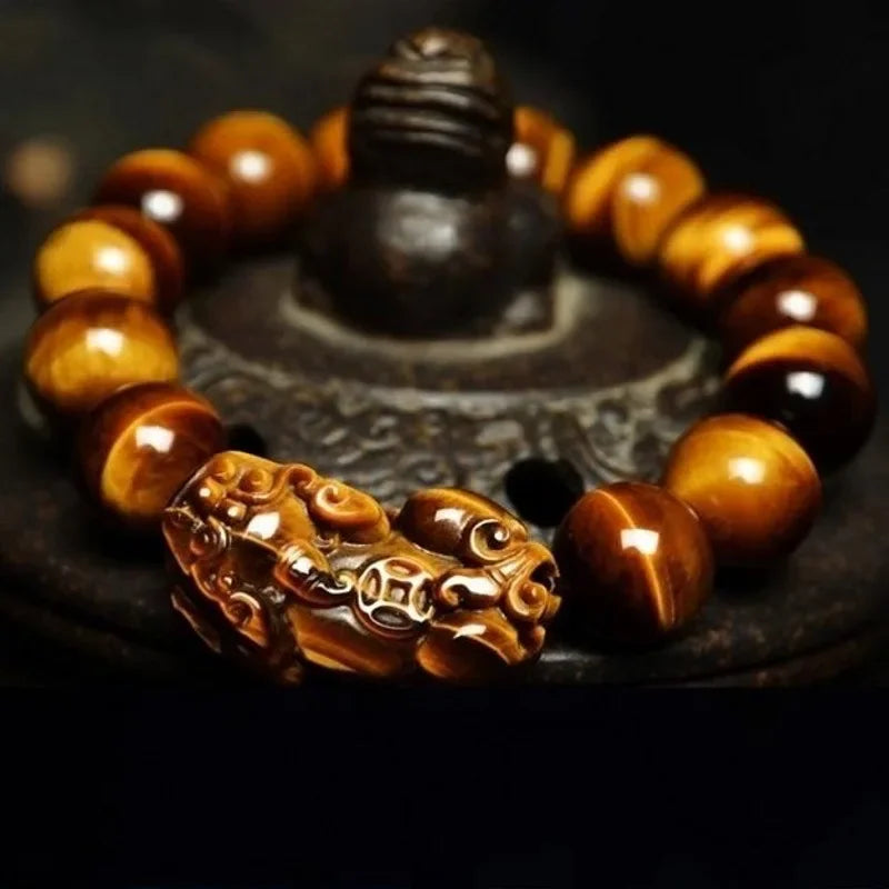 Tiger Eye Beads Feng Shui Bracelet with intricately carved Pixiu charms on a dark background, enhancing its spiritual and aesthetic appeal.