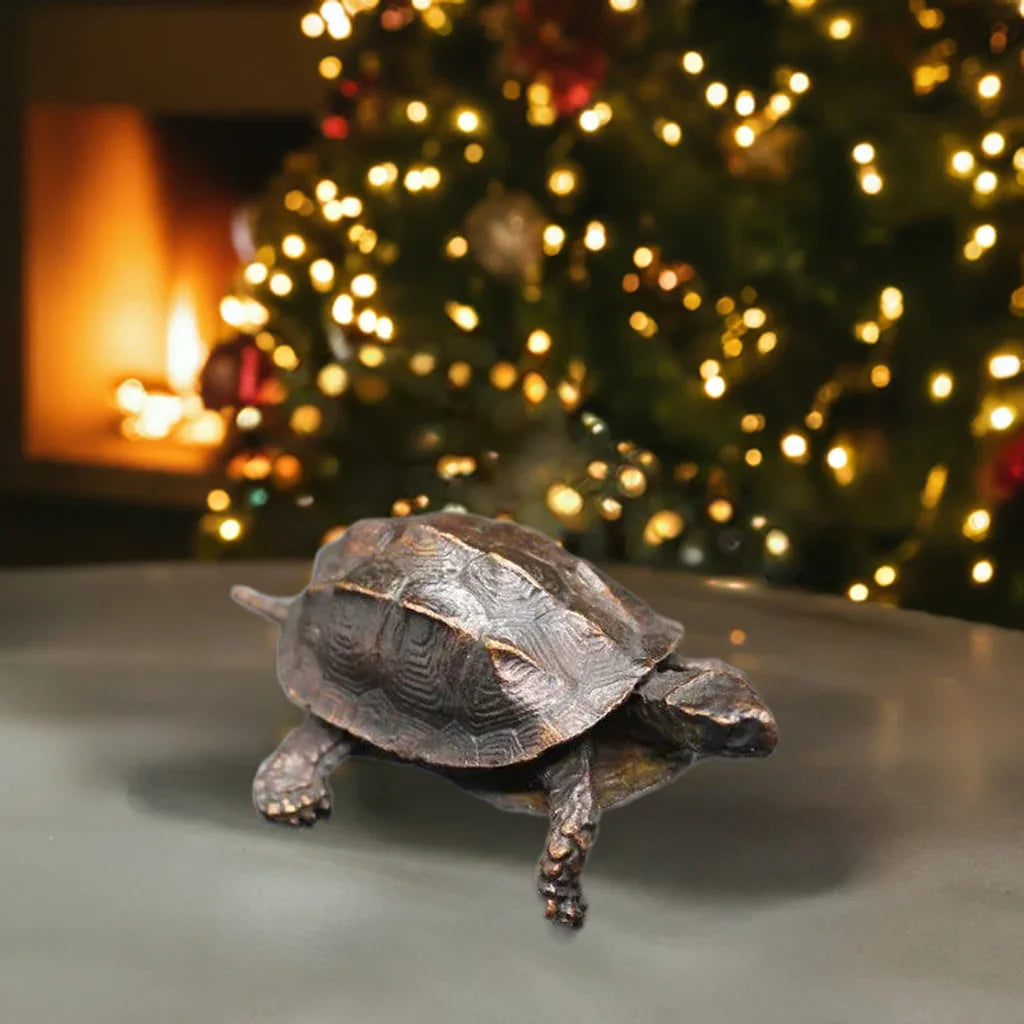Antique Chinese copper turtle statue displayed near a Christmas tree, perfect as a Feng Shui home decor accessory or festive tabletop figurine.