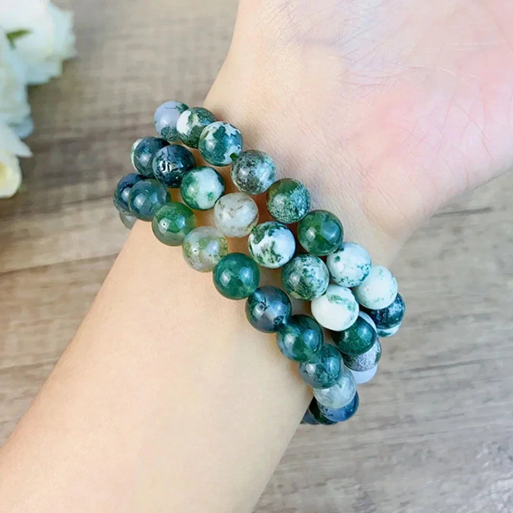 Fashionable 8MM Moss Agate Crystal Bracelet worn on wrist, showcasing real natural energy stones for men and women.