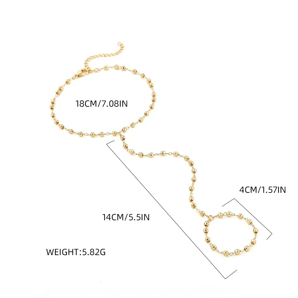 Gold-plated hand chain bracelet with faceted beads and finger ring, shown with measurements and weight for product detail reference.
