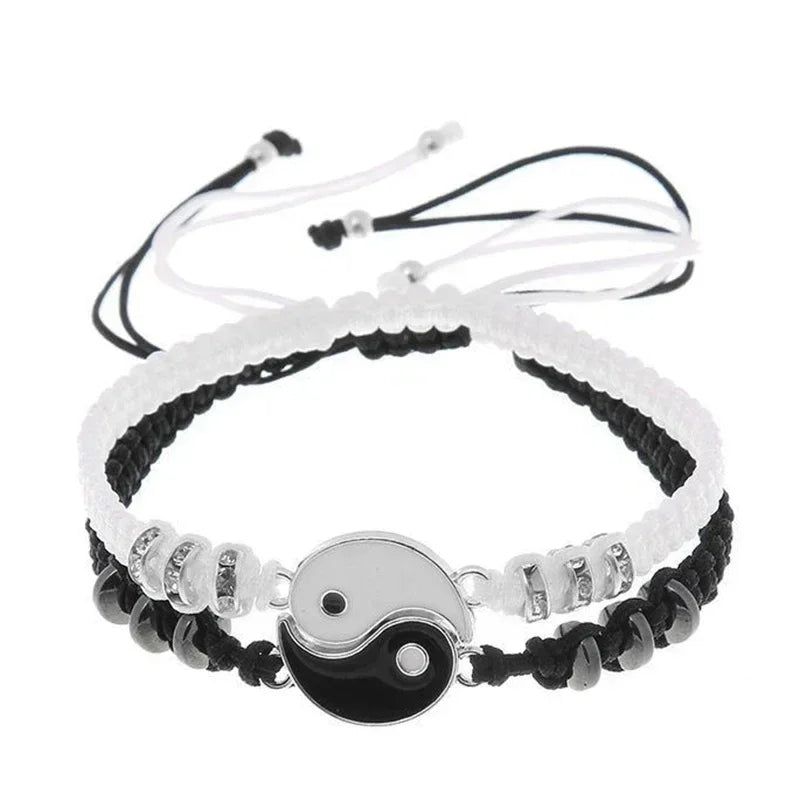 Black and white handmade couple bracelets with silver-tone Yin Yang charm and adjustable woven cords for a balanced look.