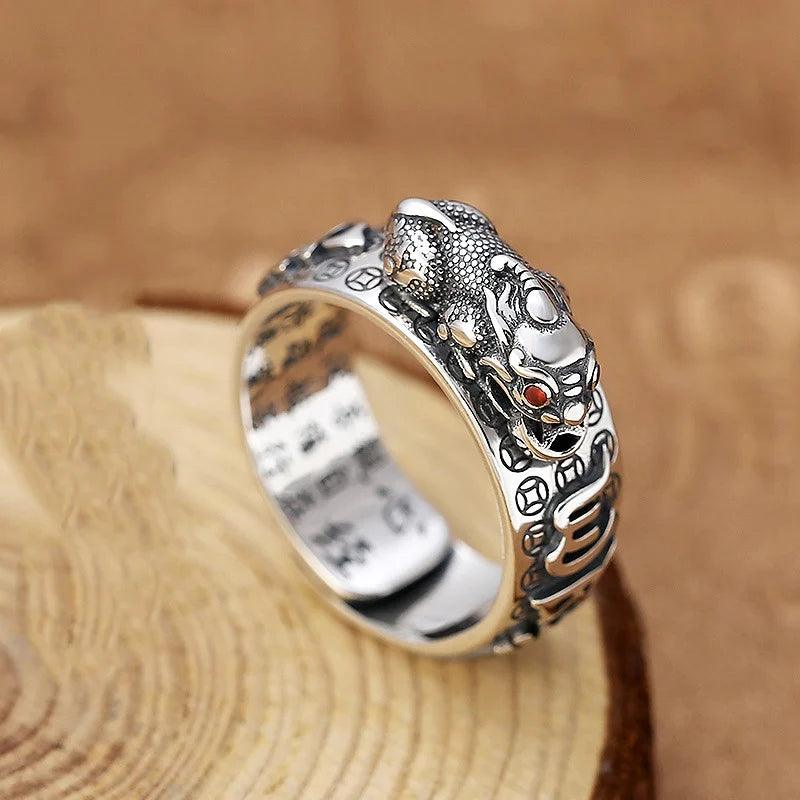 Feng Shui Pixiu Ring Silver Adjustable Wealth Amulet with silver Pixiu and red gemstone eye, engraved with lucky symbols for men and women.