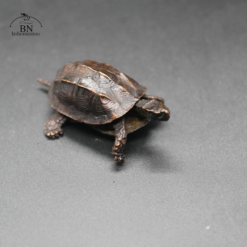 Close-up of the antique copper turtle figurine, a Feng Shui-inspired desk ornament and Chinese home decor collectible.