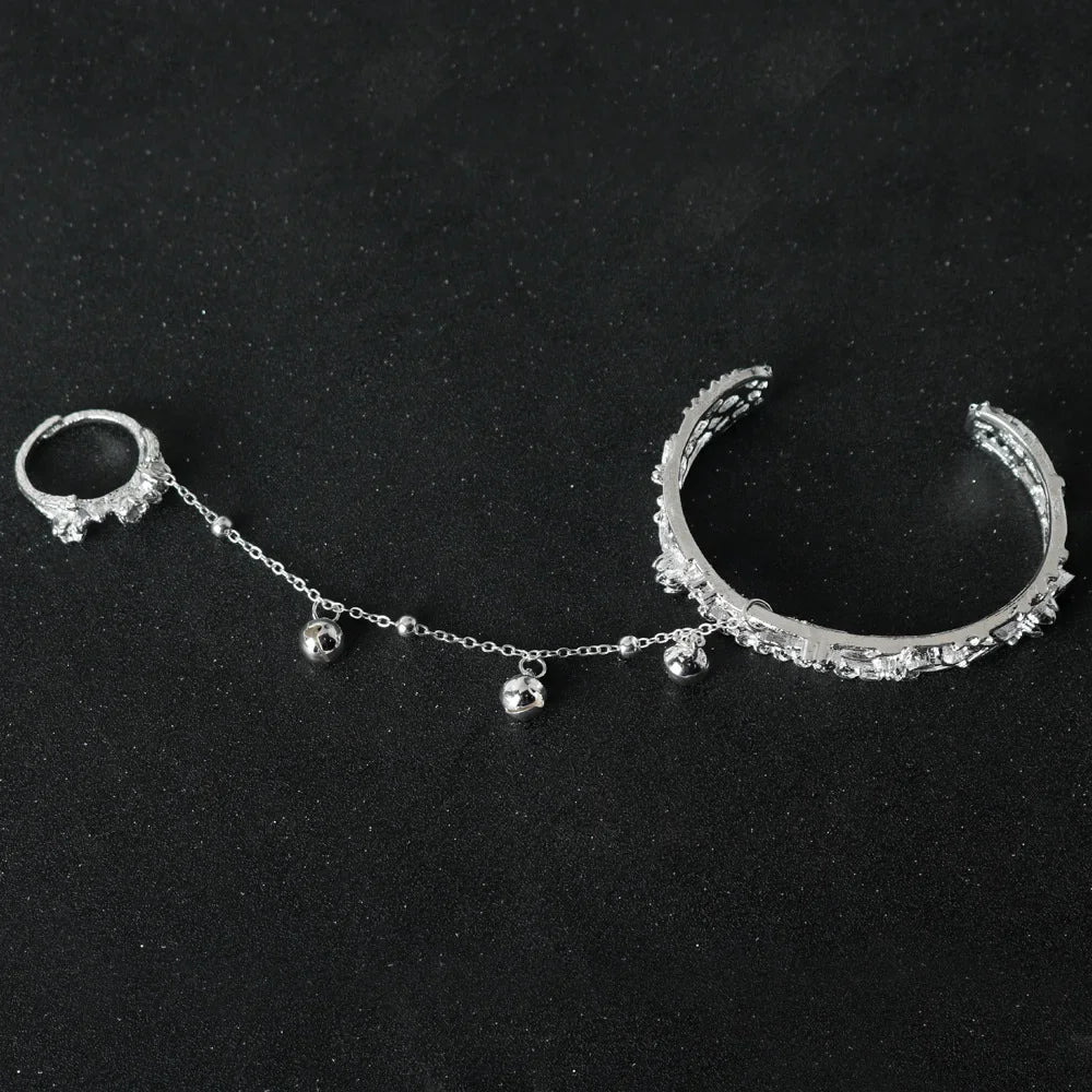 TGCF Hua Cheng & Xie Lian cosplay bracelet with bell charms and chain link, laid on black surface, perfect for costume accessory styling.