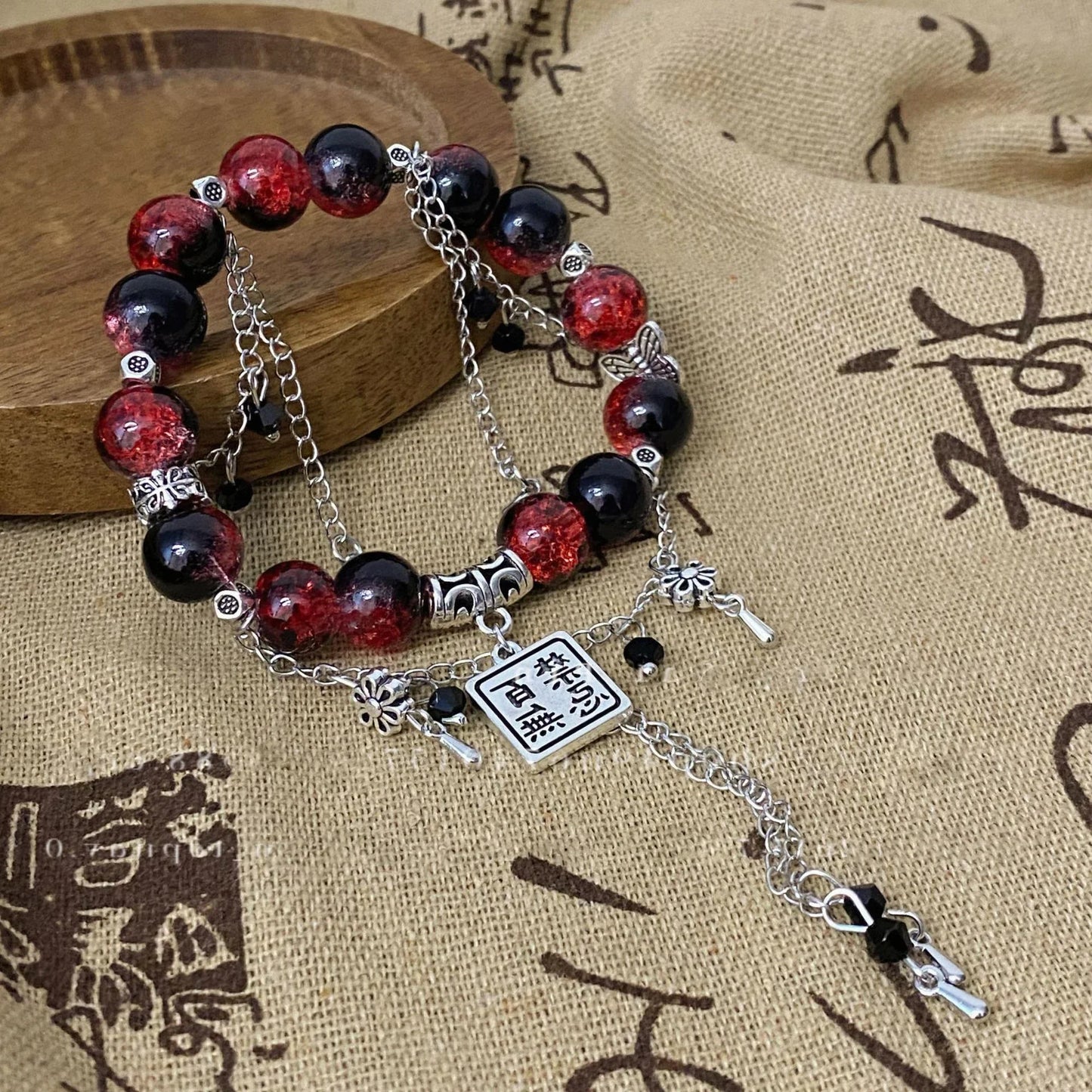 TGCF Cosplay Bracelet Set featuring red and black beaded bracelet with silver charms inspired by Xie Lian & Hua Cheng from Heaven Official’s Blessing.