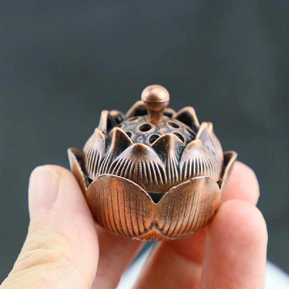 Miniature bronze lotus-shaped incense holder with detailed petal design, perfect for Feng Shui meditation and home fragrance rituals.