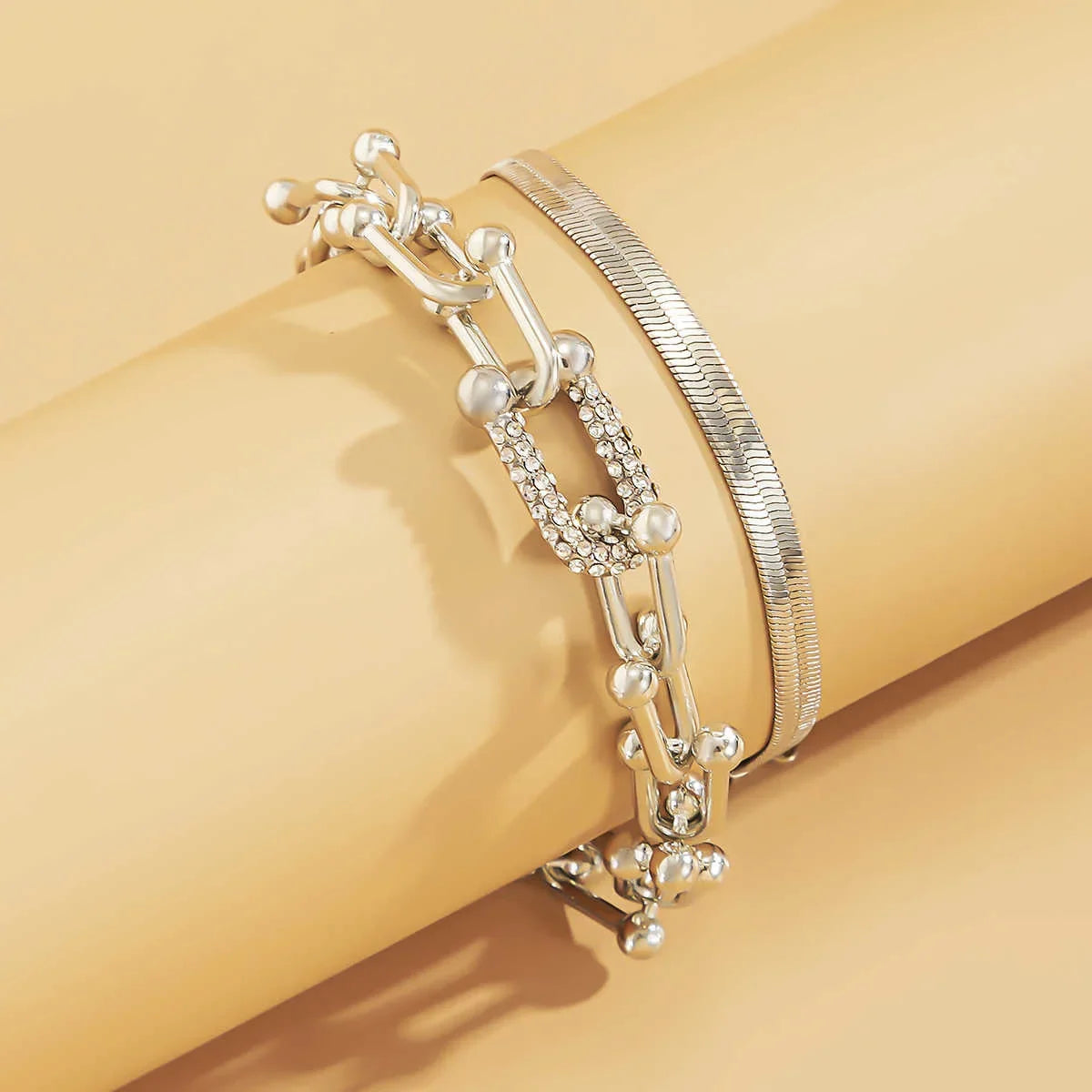 Silver-tone version of Trendy Geometric Bracelet Set – 2Pcs U Chain with rhinestone accents, displayed on beige background.