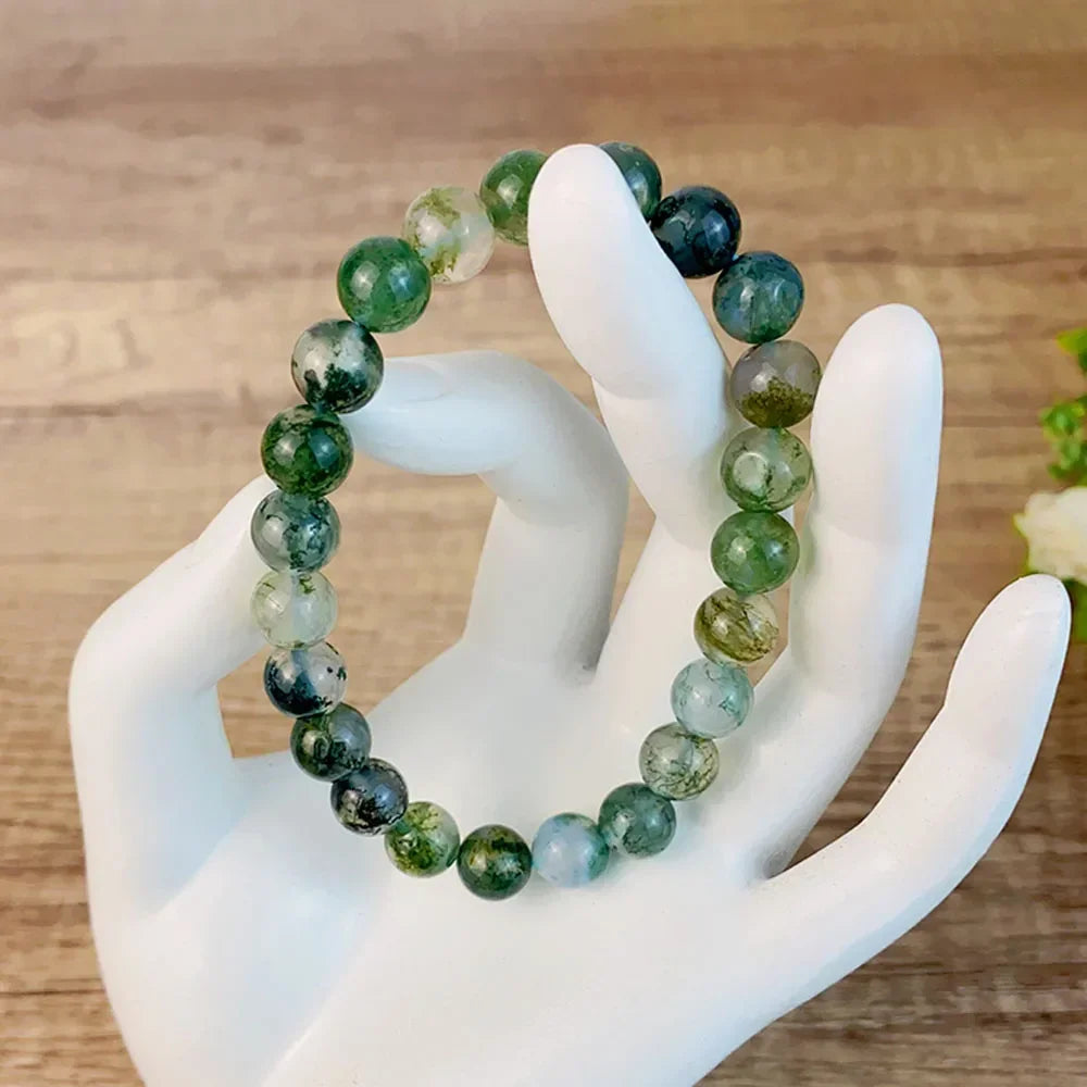 8MM Moss Agate Energy Bracelet held by a display hand, featuring real natural stones for meditation and fengshui use.