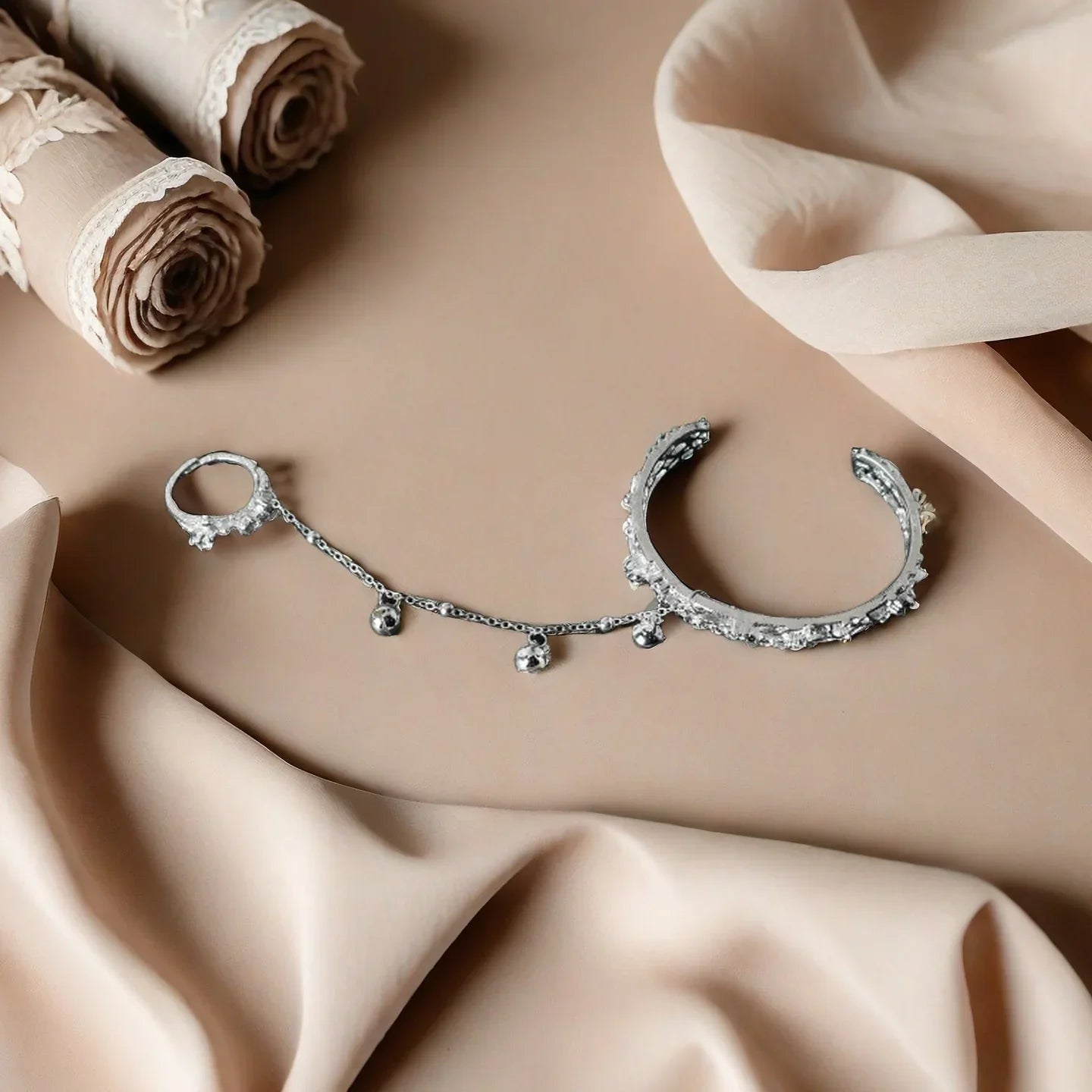 TGCF Hua Cheng & Xie Lian cosplay bracelet set on beige fabric, showcasing bell ring bangle and adjustable ring for costume accessory styling.