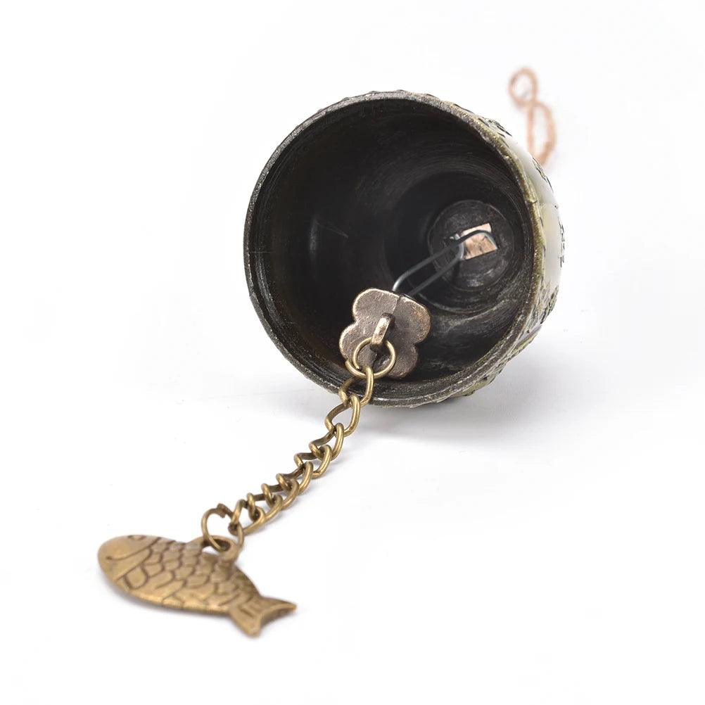Close-up of the interior of the Lucky Feng Shui Wind Chime Buddha Bell with chain and fish charm, designed for peaceful sound and decor.