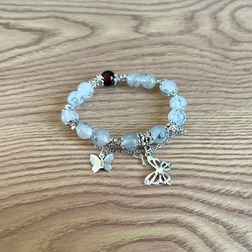 White and silver beaded bracelet from TGCF Cosplay Bracelet Set with butterfly charms, inspired by Xie Lian from Heaven Official’s Blessing anime.