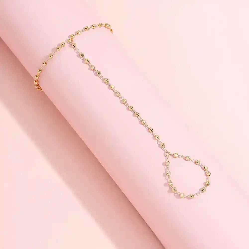 Gold-Plated Faceted Bead Hand Chain Bracelet with Linked Finger Ring – Eye-Catching Fashion GoddessJewelry for Modern 1