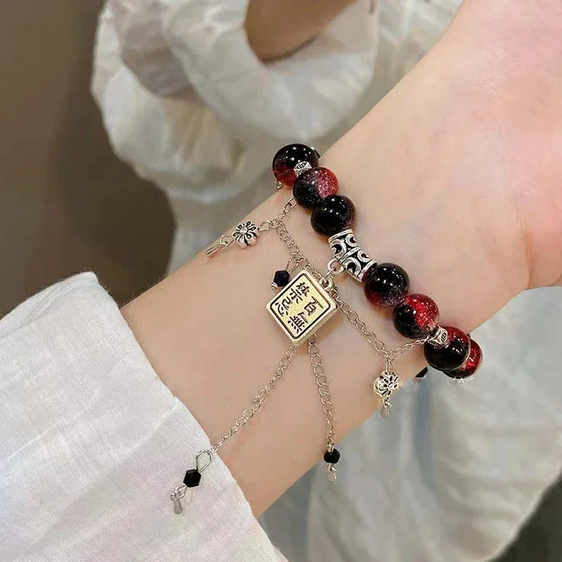 Xie Lian & Hua Cheng inspired TGCF Cosplay Bracelet Set worn on wrist, showcasing red-black beads and silver chain charms for anime fans.