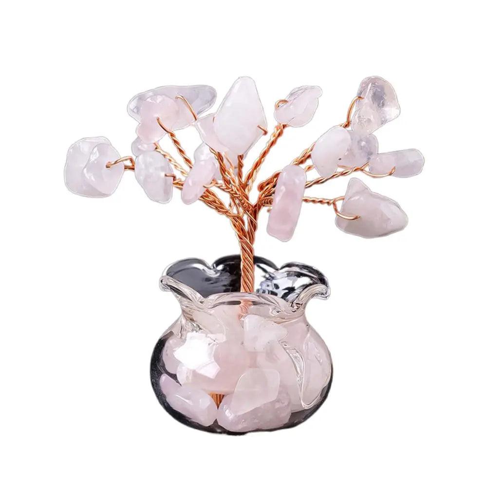 Pink rose quartz Handmade Feng Shui Crystal Tree Decor for Healing Energy with soft crystal chips and copper wire in a decorative glass pot.
