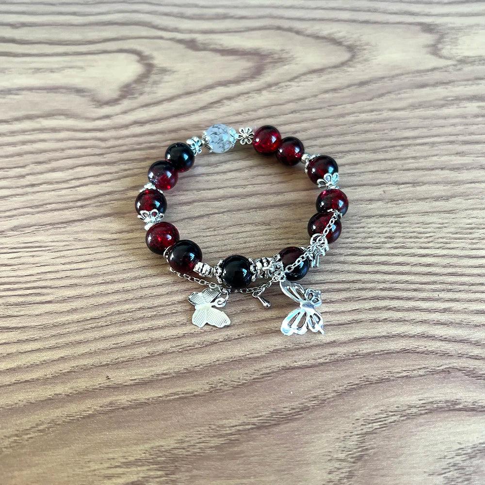 Red and black beaded bracelet with butterfly and flower charms from TGCF Cosplay Bracelet Set, ideal for Xie Lian & Hua Cheng anime cosplay.