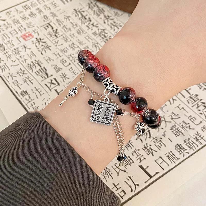 Detailed view of TGCF Cosplay Bracelet Set with red-black beads and engraved silver charms, ideal for Heaven Official’s Blessing cosplay looks.